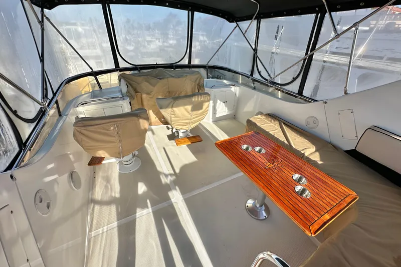 Slide: The Image of Interior of 2003 Ocean Alexander 42 Sport Sedan with seating and wooden table. - 26