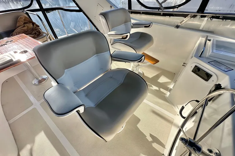 Slide: The Image of 2003 Ocean Alexander 42 Sport Sedan helm with comfortable seating and steering wheel. - 29