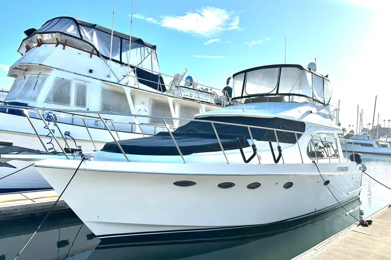 Slide: The Image of 2003 Ocean Alexander 42 Sport Sedan yacht docked at marina under clear sky. - 3