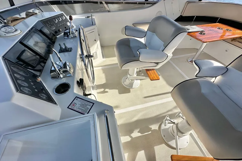 Slide: The Image of 2003 Ocean Alexander 42 Sport Sedan helm with modern controls and comfortable seating. - 32