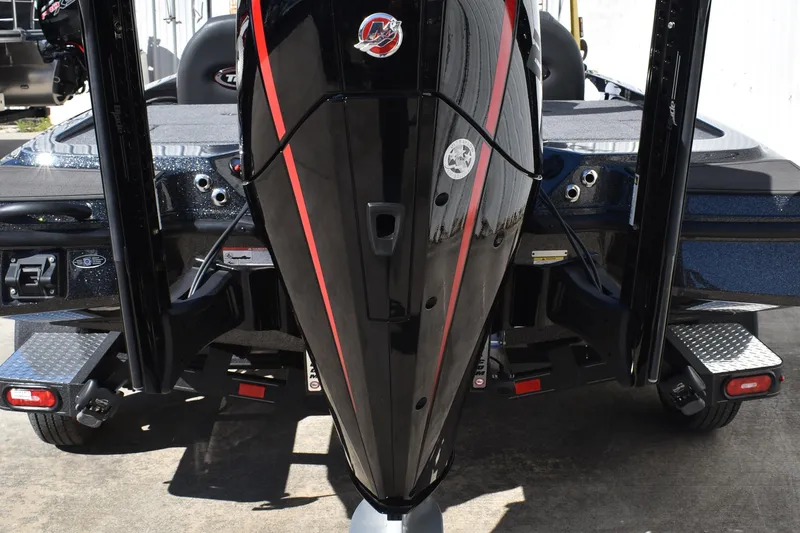 Slide: The Image of 2025 Triton 20XP Patriot boat dashboard with Lowrance electronics and storage compartments. - 11