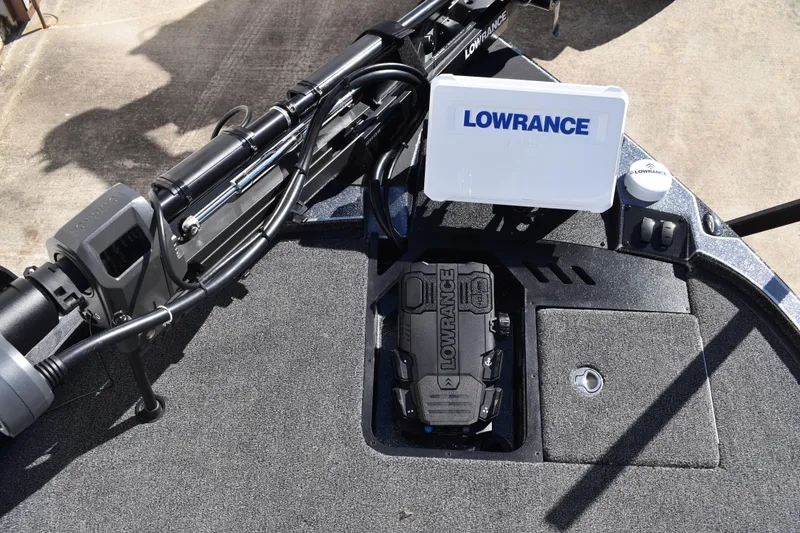 Slide: The Image of 2025 Triton 20XP Patriot boat dashboard with Lowrance equipment and control switches. - 16