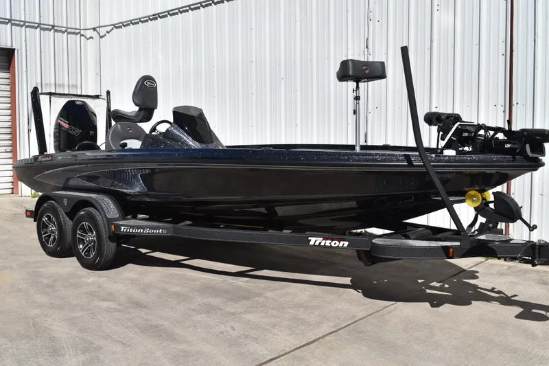 Slide: The Image of 2025 Triton 20XP Patriot boat logo on a sleek, metallic surface. - 2