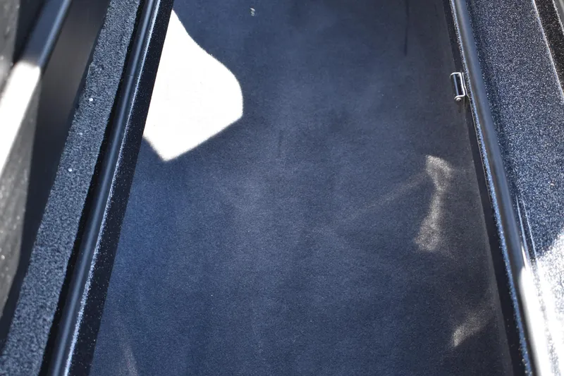 Slide: The Image of Interior of 2025 Triton 20XP Patriot boat with seating and storage compartments. - 21