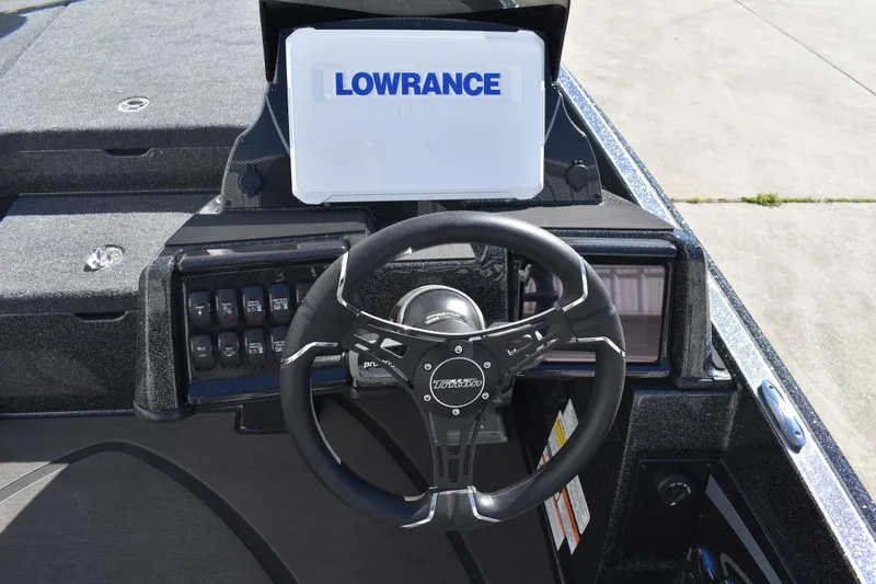 Slide: The Image of 2025 Triton 20XP Patriot boat interior with dual gray seats and steering console. - 29