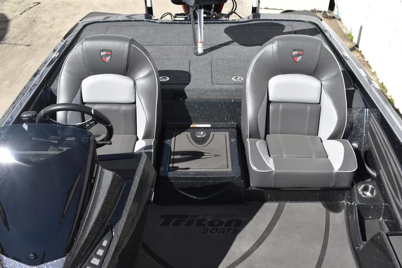 Slide: The Image of 2025 Triton 20XP Patriot boat storage compartments with open lids, showcasing interior space. - 36