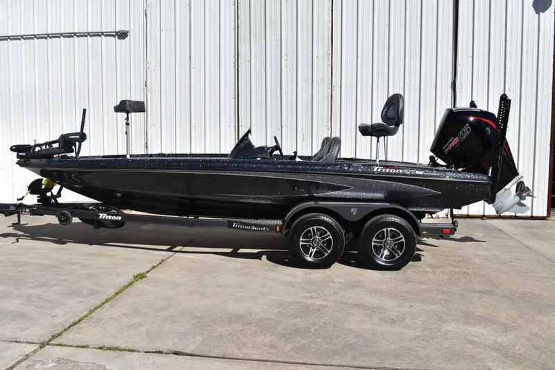Slide: The Image of 2025 Triton 20XP Patriot boat, black, parked on trailer, side view. - 6