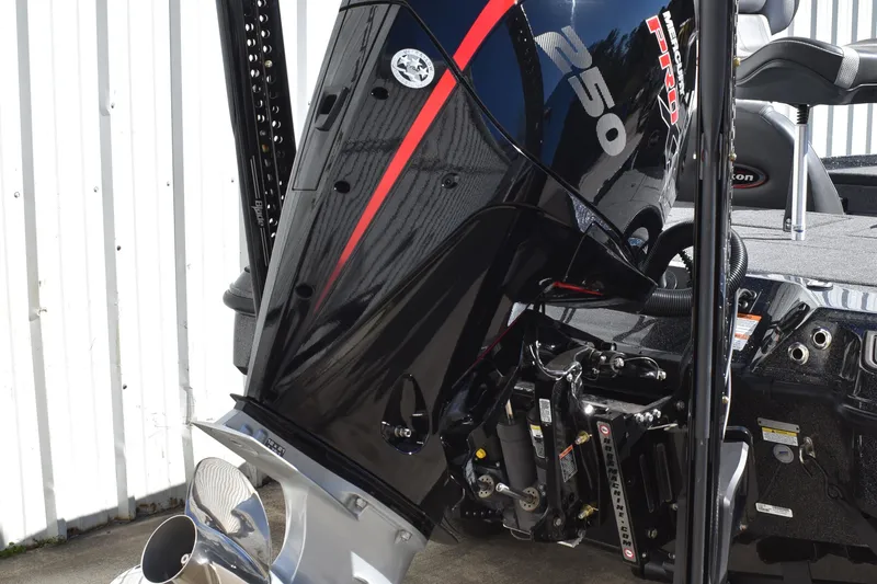 Slide: The Image of 2025 Triton 20XP Patriot boat deck with carpeted surface and storage compartments. - 9