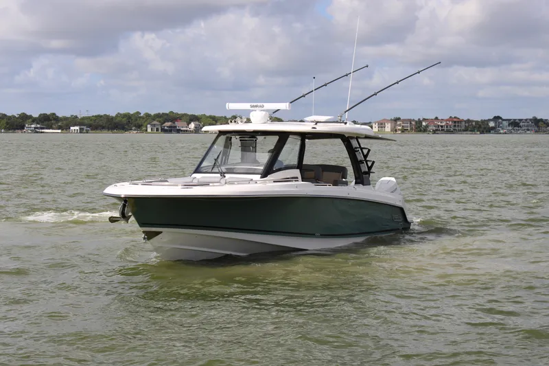 Slide: The Image of 2026 Boston Whaler 350 Realm on calm water, featuring fishing rods and a sleek design. - 7