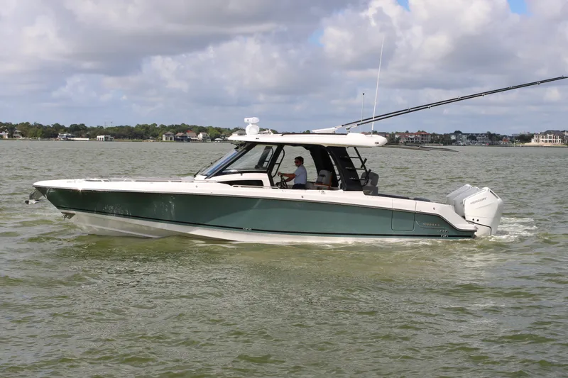 Slide: The Image of Boston Whaler 350 Realm 2026 on calm water with a cloudy sky in the background. - 0