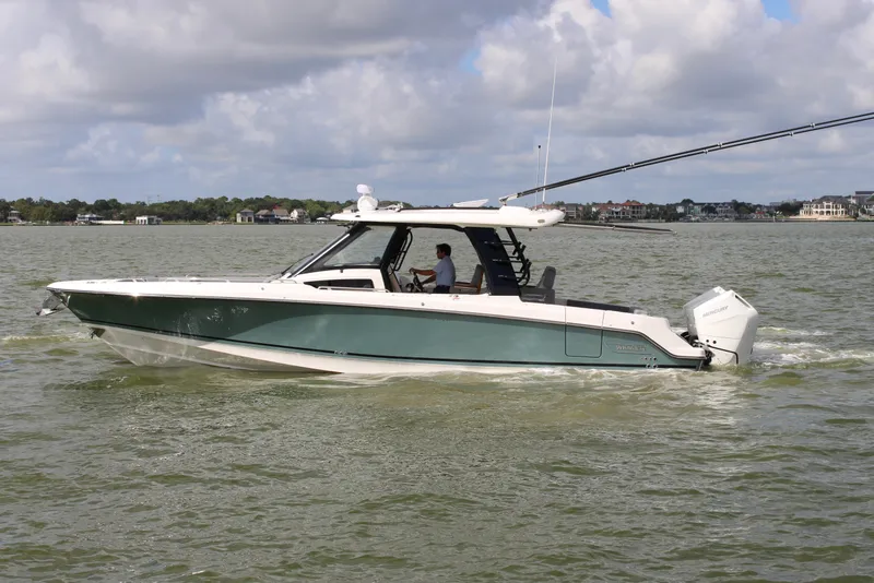 Slide: The Image of Boston Whaler 350 Realm 2026 on calm water with a cloudy sky in the background. - 8