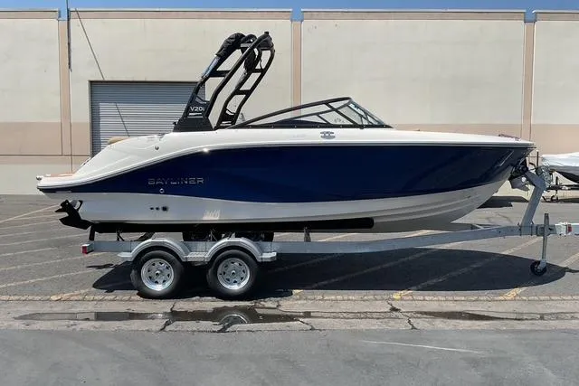 The Image of 2025 Bayliner V20i boat on trailer, parked outdoors, side view. - 0