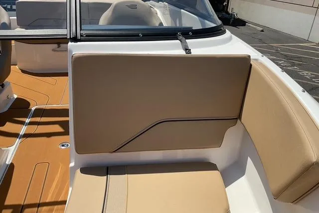 Slide: The Image of 2025 Bayliner V20i boat interior with tan seating and sleek design. - 11