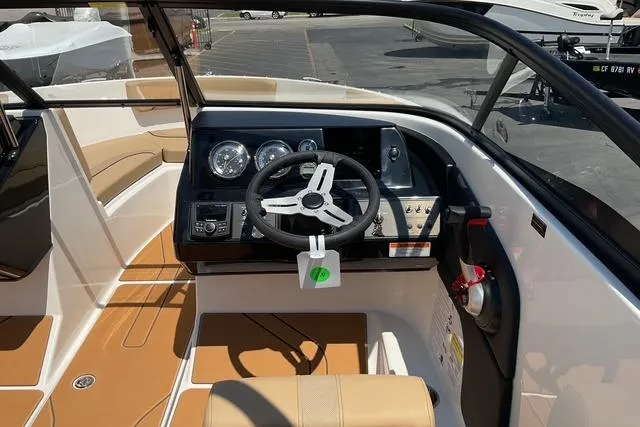 Slide: The Image of 2025 Bayliner V20i boat interior with steering wheel and dashboard controls. - 13