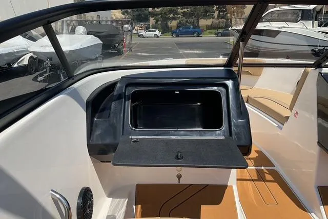 Slide: The Image of 2025 Bayliner V20i boat interior with open storage compartment and seating area. - 14
