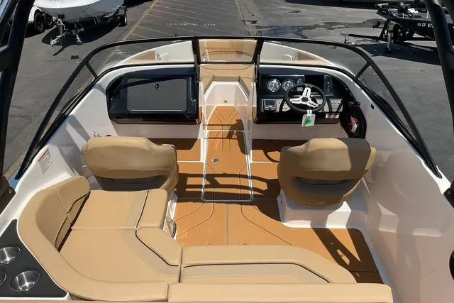 Slide: The Image of 2025 Bayliner V20i boat interior with tan seating and modern dashboard. - 15