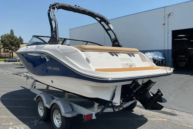 Slide: The Image of 2025 Bayliner V20i boat on trailer, parked outdoors near a building. - 5