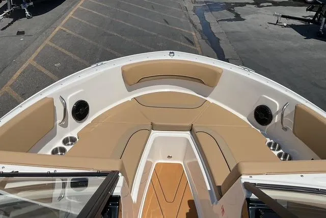 Slide: The Image of 2025 Bayliner V20i boat interior with tan seating and cup holders. - 8