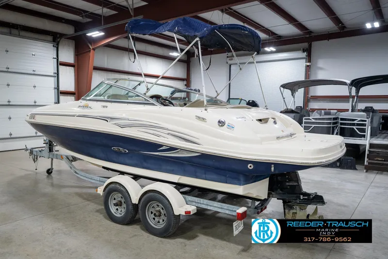 Slide: The Image of 2005 Sea Ray 200 Sundeck boat in indoor storage facility, rear view. - 10