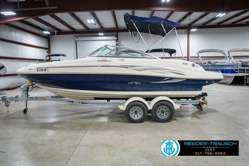 Slide: The Image of 2005 Sea Ray 200 Sundeck boat on trailer in indoor showroom. - 11