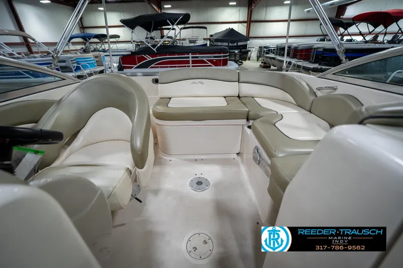 Slide: The Image of 2005 Sea Ray 200 Sundeck interior with steering wheel and seating, displayed indoors. - 18