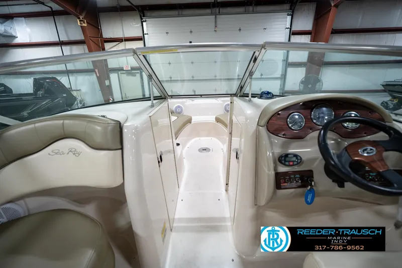 Slide: The Image of 2005 Sea Ray 200 Sundeck interior with beige seating in a showroom. - 21