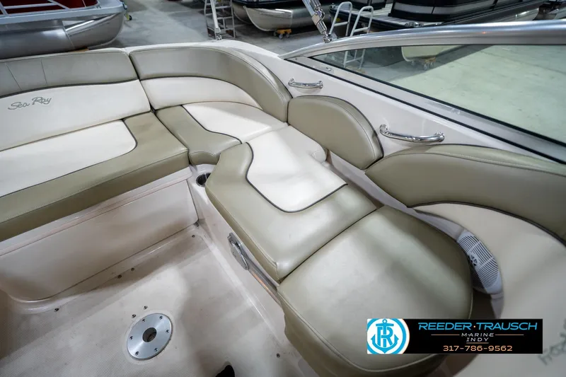 Slide: The Image of Interior of a 2005 Sea Ray 200 Sundeck boat with beige seating. - 25