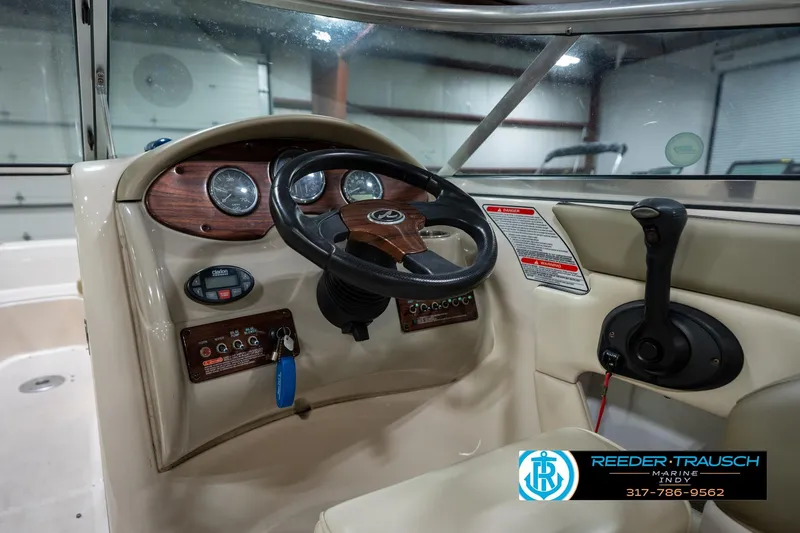Slide: The Image of 2005 Sea Ray 200 Sundeck boat interior with steering wheel and control panel. - 27