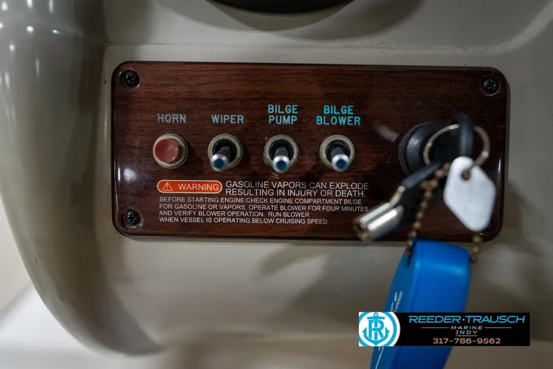 Slide: The Image of 2005 Sea Ray 200 Sundeck boat dashboard with steering wheel and controls in a showroom. - 28