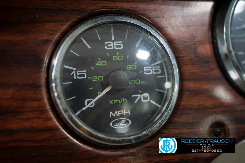 Slide: The Image of Control panel of a 2005 Sea Ray 200 Sundeck with warning label and keys. - 30