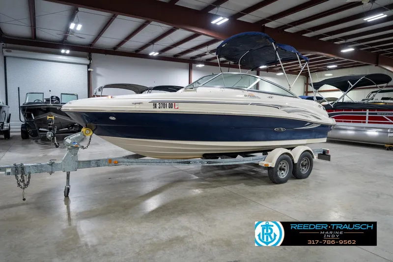 Slide: The Image of 2005 Sea Ray 200 Sundeck boat on trailer in indoor showroom. - 4