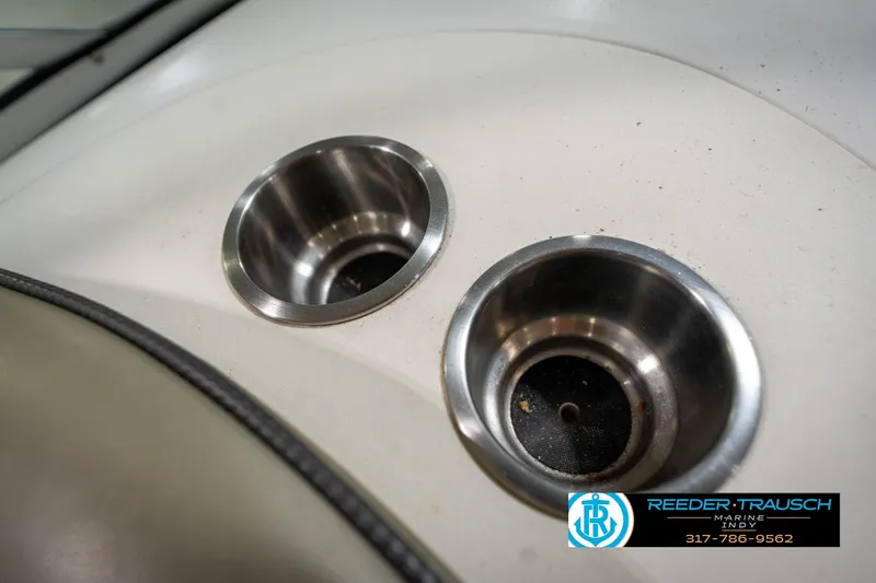 Slide: The Image of 2005 Sea Ray 200 Sundeck interior with beige seating in a showroom. - 40