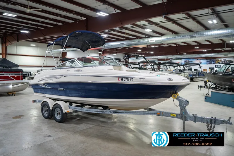 Slide: The Image of 2005 Sea Ray 200 Sundeck boat in indoor showroom on trailer. - 6