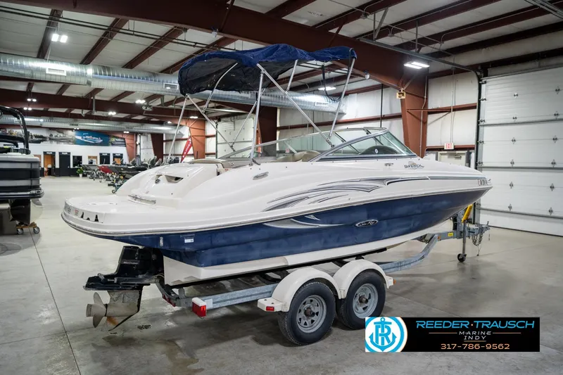 Slide: The Image of 2005 Sea Ray 200 Sundeck boat on trailer in indoor showroom. - 8