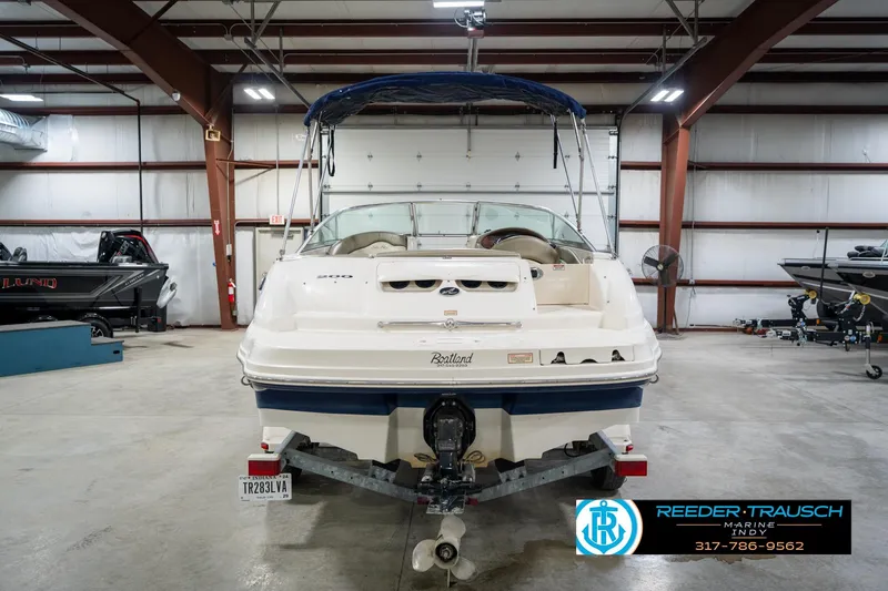 Slide: The Image of 2005 Sea Ray 200 Sundeck boat on trailer in indoor showroom. - 9