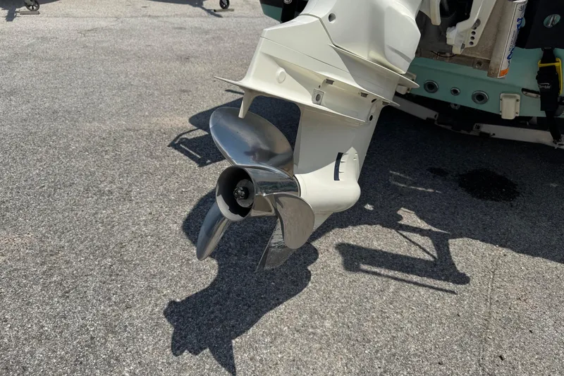 Slide: The Image of Close-up of a 2017 Epic 22 Sport Console boat propeller on pavement. - 11