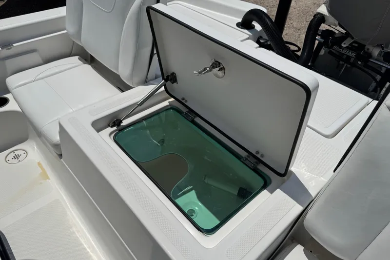 Slide: The Image of 2017 Epic 22 Sport Console boat with open storage compartment and seating area. - 18
