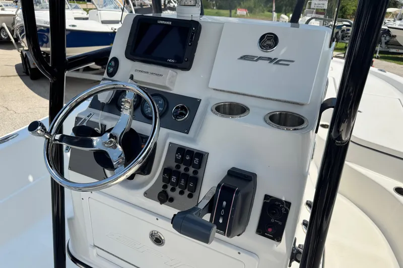 Slide: The Image of 2017 Epic 22 Sport Console boat dashboard with steering wheel and controls. - 23