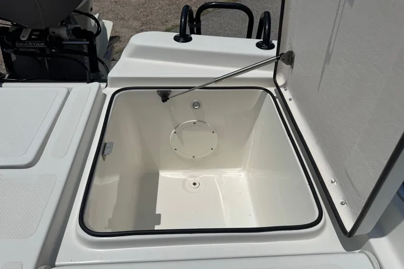 Slide: The Image of Open storage compartment on a 2017 Epic 22 Sport Console boat. - 25
