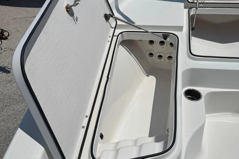 Slide: The Image of Open storage compartment on 2017 Epic 22 Sport Console boat, showcasing interior design. - 27