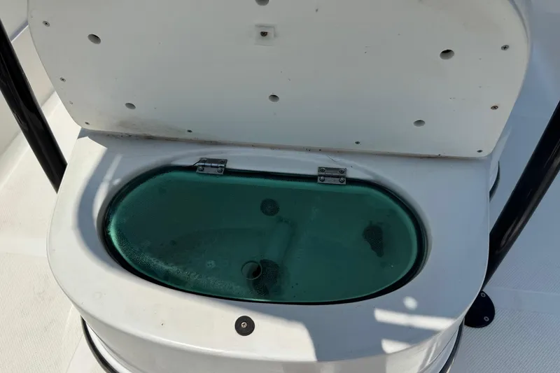 Slide: The Image of Livewell on 2017 Epic 22 Sport Console boat, open lid, green-tinted cover. - 29