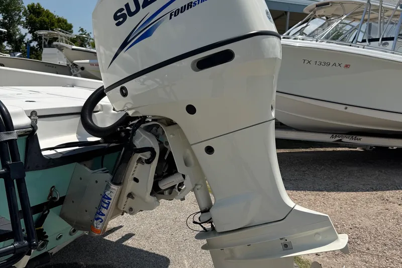 Slide: The Image of Outboard motor on a 2017 Epic 22 Sport Console boat, parked on a trailer. - 30