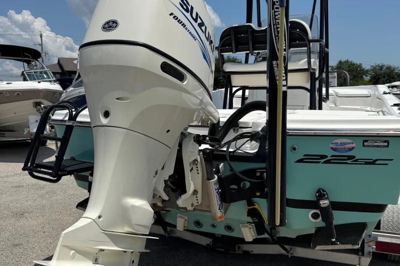 Slide: The Image of 2017 Epic 22 Sport Console boat with Suzuki outboard motor, docked in a marina. - 31