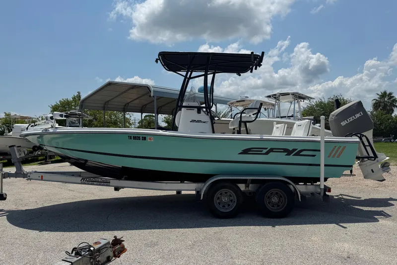 Slide: The Image of 2017 Epic 22 Sport Console boat on trailer, featuring Suzuki outboard motor. - 4