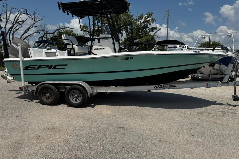 Slide: The Image of 2017 Epic 22 Sport Console boat on trailer, parked outdoors under a clear sky. - 5