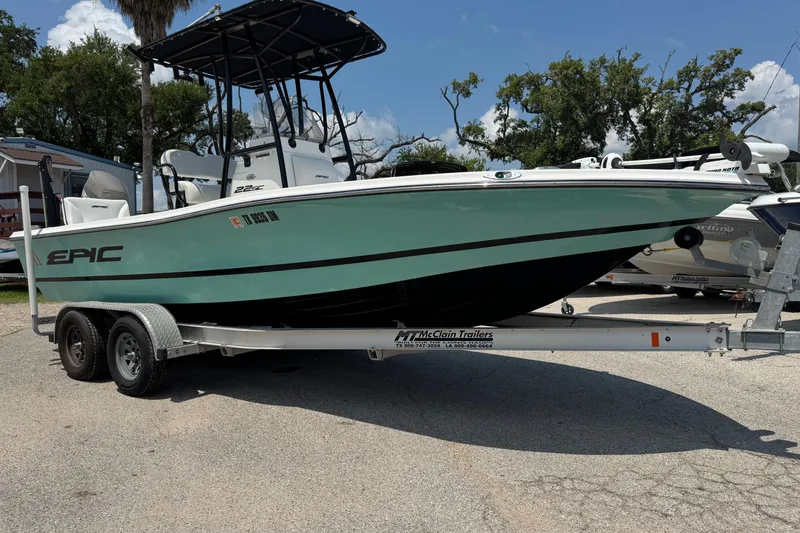 Slide: The Image of 2017 Epic 22 Sport Console boat on trailer, parked outdoors under clear sky. - 6