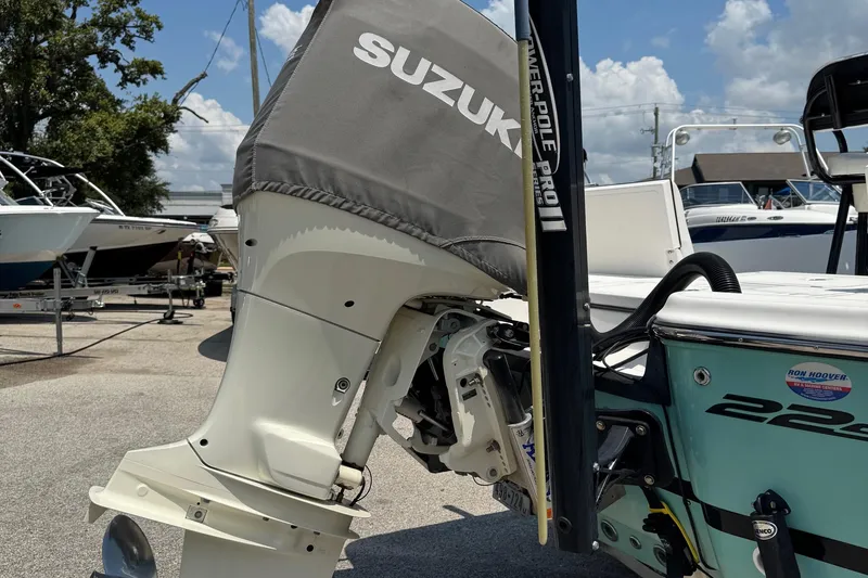 Slide: The Image of 2017 Epic 22 Sport Console with Suzuki outboard motor in a boatyard. - 8