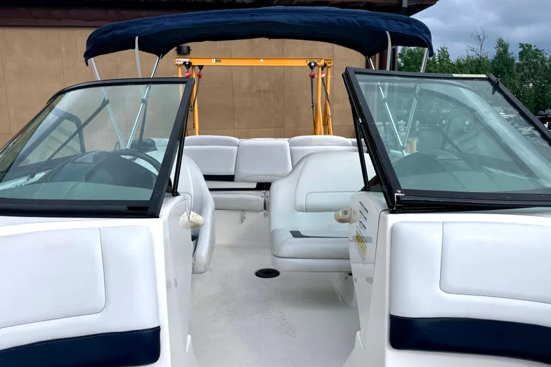 Slide: The Image of 2003 Sea-Doo Utopia 185 boat interior with white seating and blue canopy. - 15