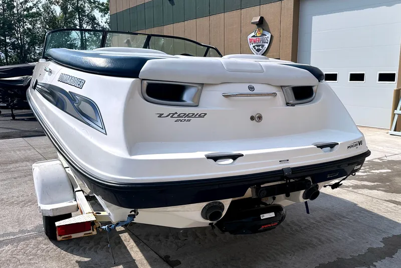 Slide: The Image of 2003 Sea-Doo Utopia 185 boat on trailer, parked outdoors near a building. - 7