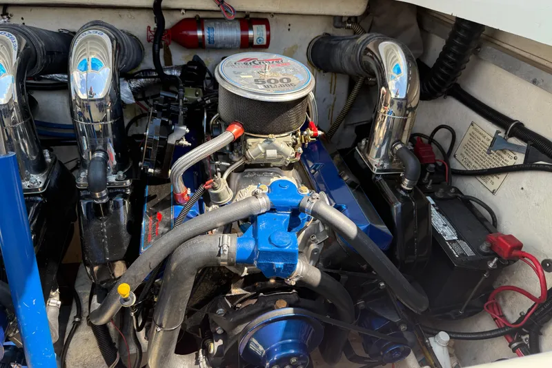 Slide: The Image of Engine of a 1995 Formula 382 SR-1 boat, featuring chrome and blue components. - 11